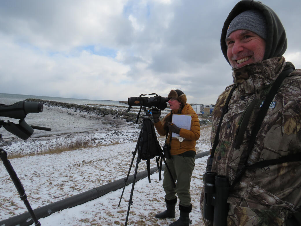 Steve McGrath and Maureen Cameron-MacMillan observe a raft of scaup in Glace Bay, February 2023. Photo by Alicia Penney.