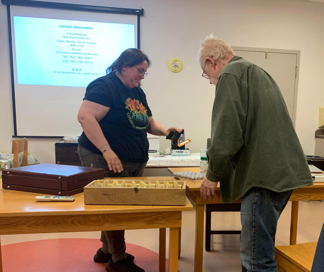Alicia Penney records a close up of Fritz McAvoy's "miscellaneous moths" container for the CB Naturalists Facebook live stream. Fritz wowed us with a presentation about his work collecting, identifying and cataloguing moths (and building his own storage!)